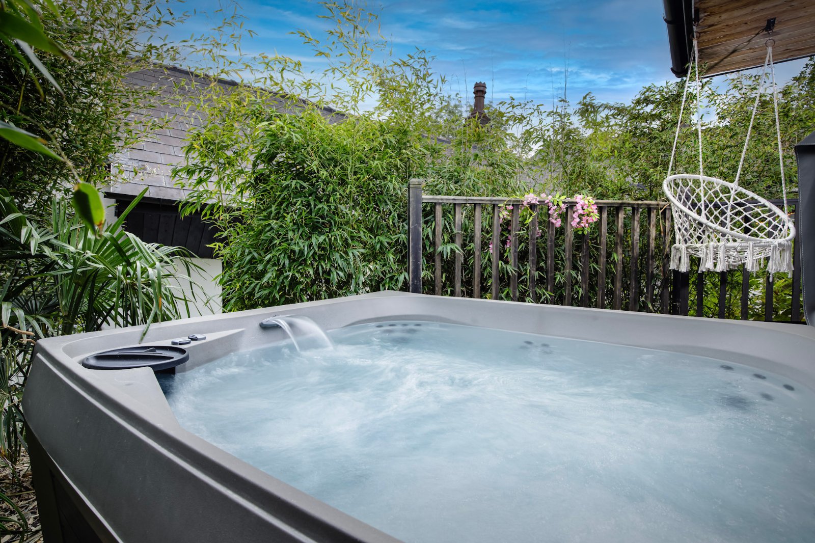 The Cottage – private outdoor hot tub in a tropical bamboo garden with a waterfall