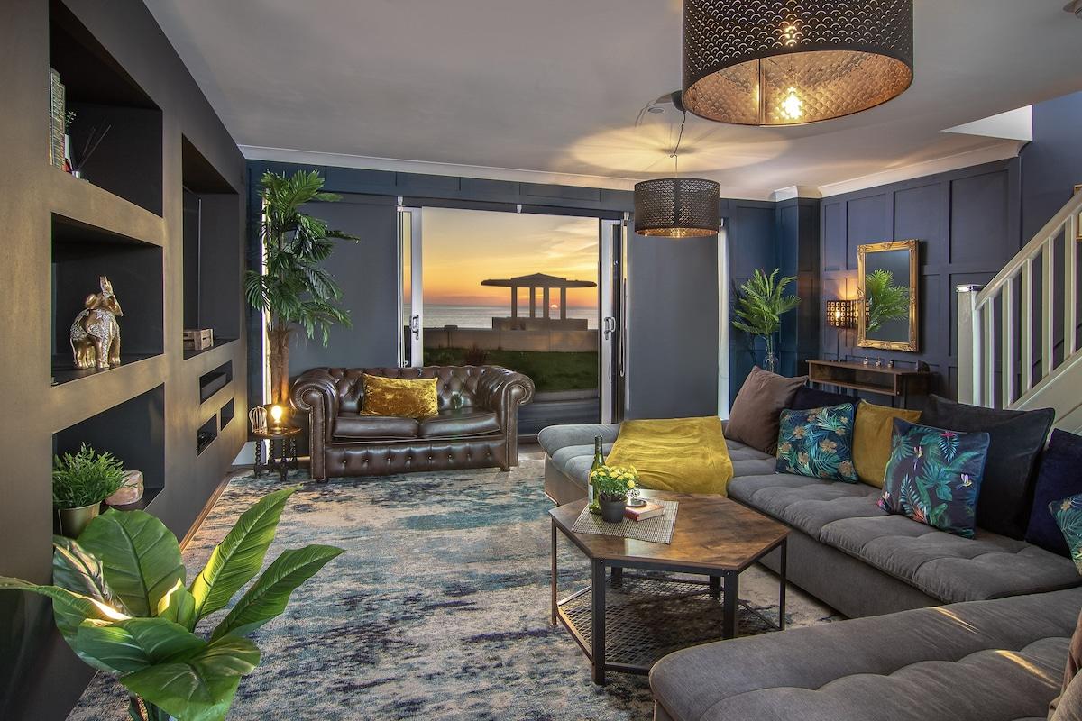 The Pad: Relax in our large luxurious living room whilst you gaze out into the ocean with beautiful sunsets.